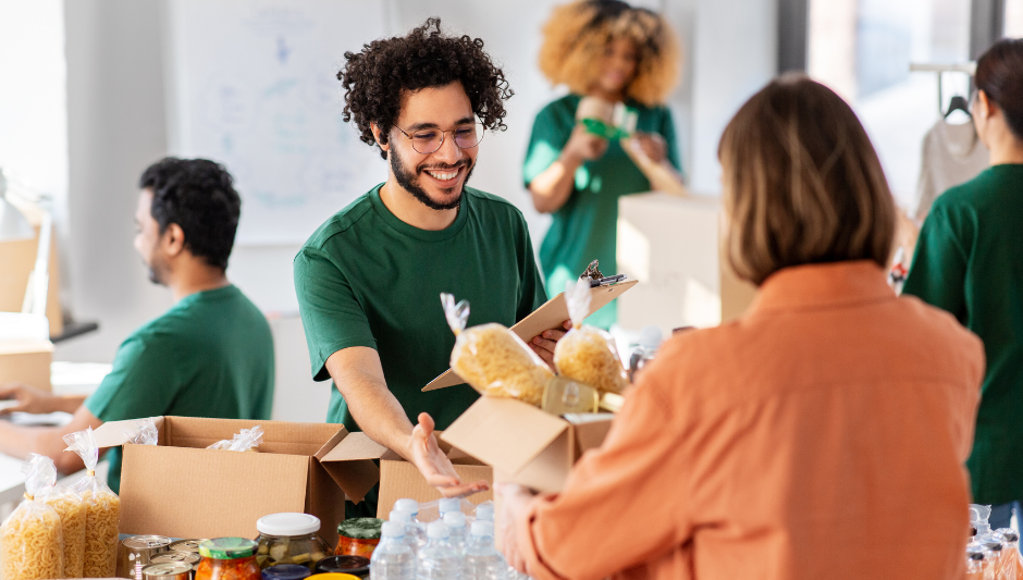 Holiday food bank volunteer giving out a food box